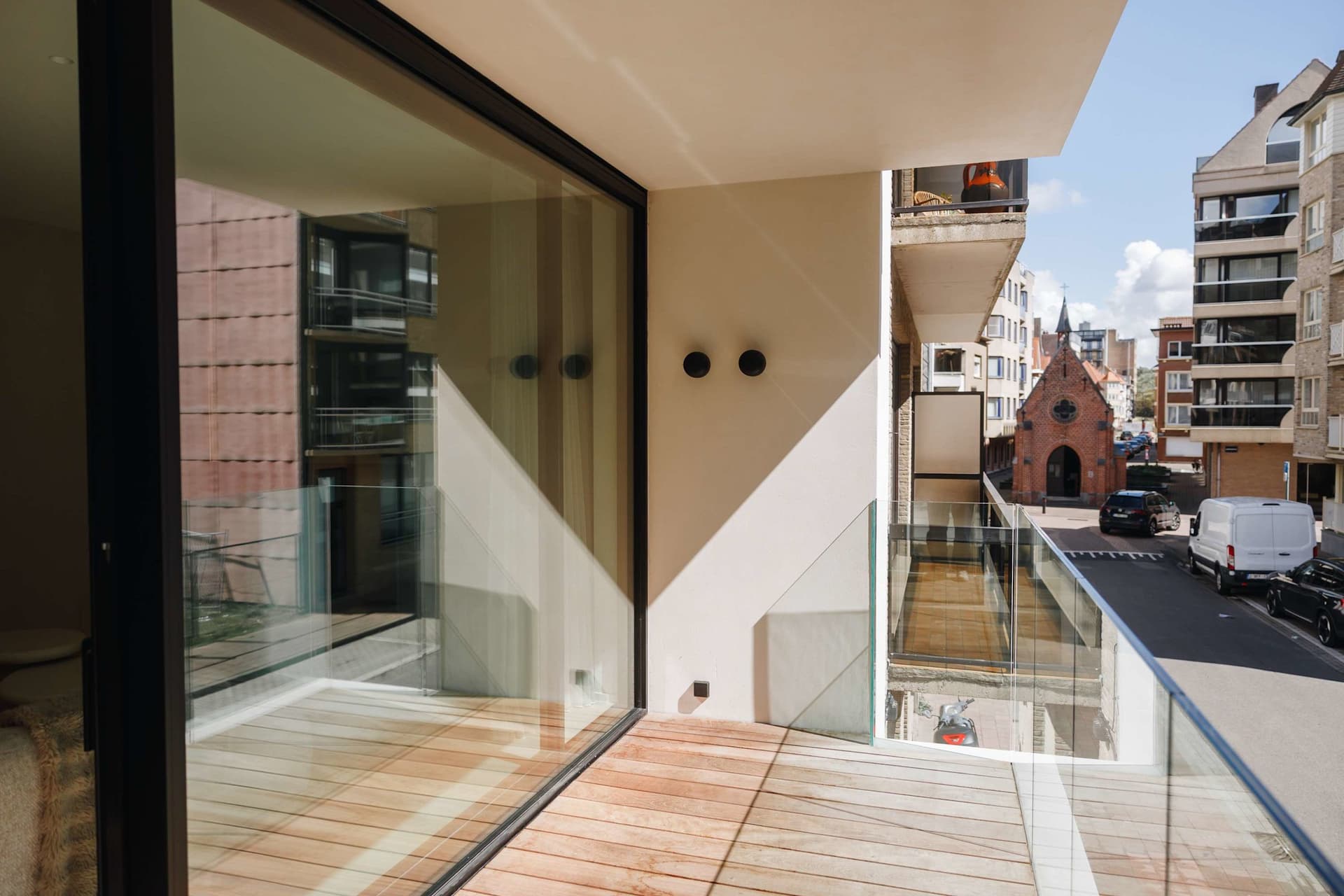 Front terrace with glass balustrade, view of the brick chapel.