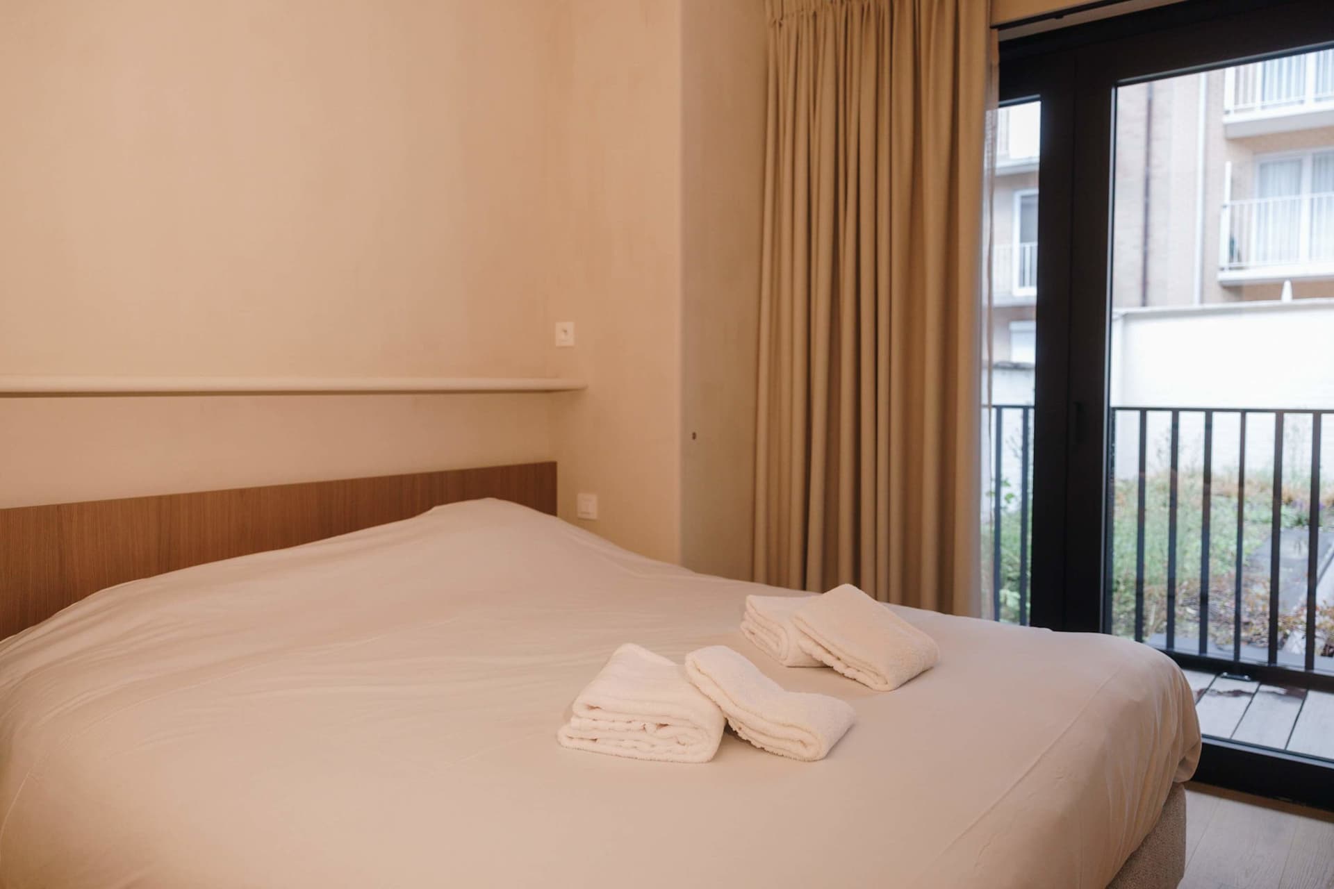 Bedroom 1 with double bed and door to the terrace.